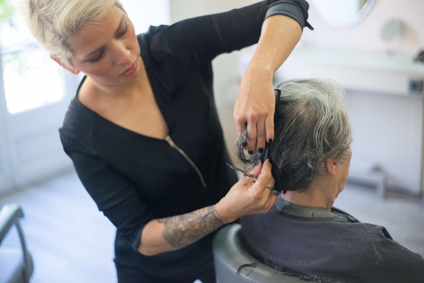 Stylist cutting hair